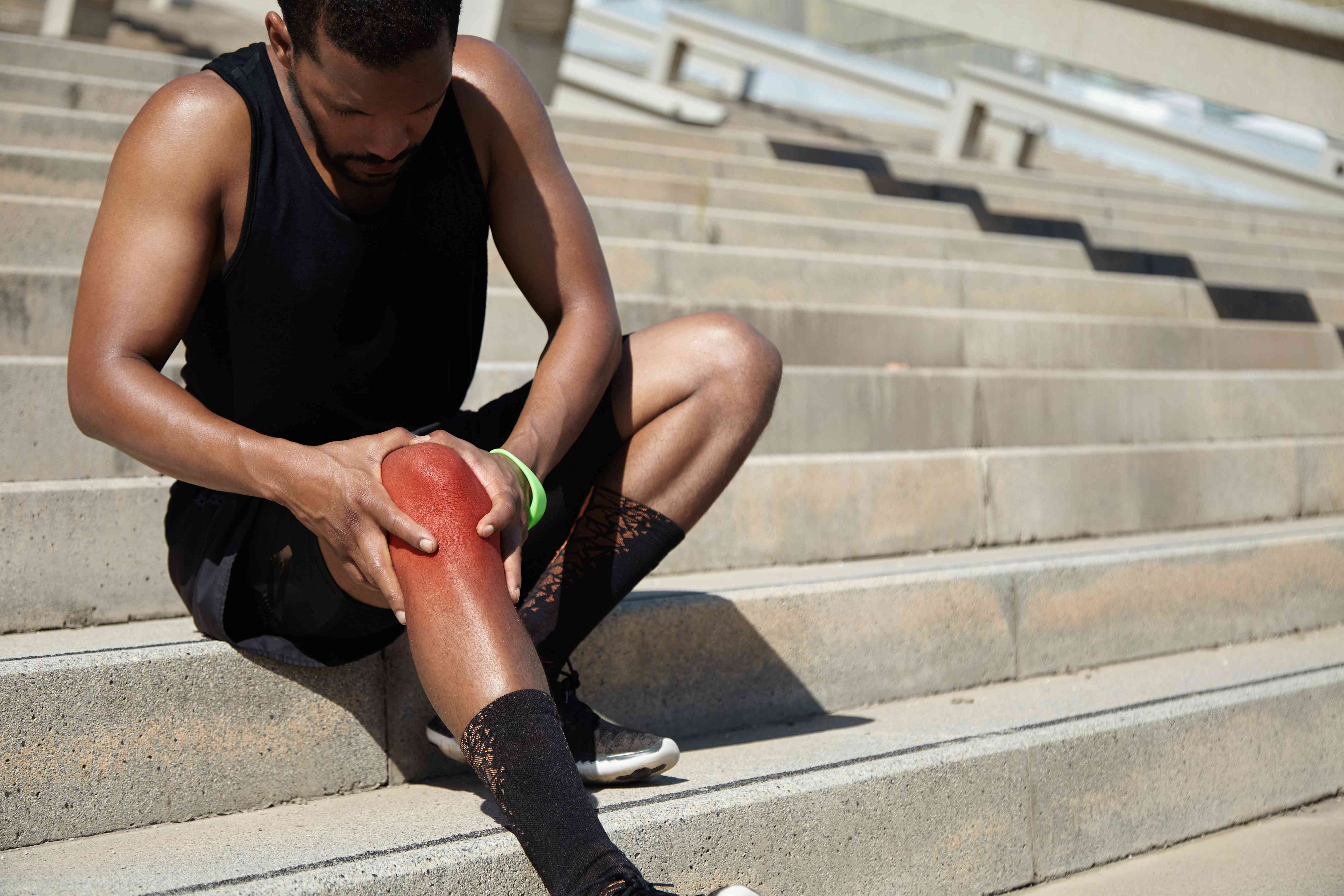 closeup-young-man-with-knee-injury-compressed