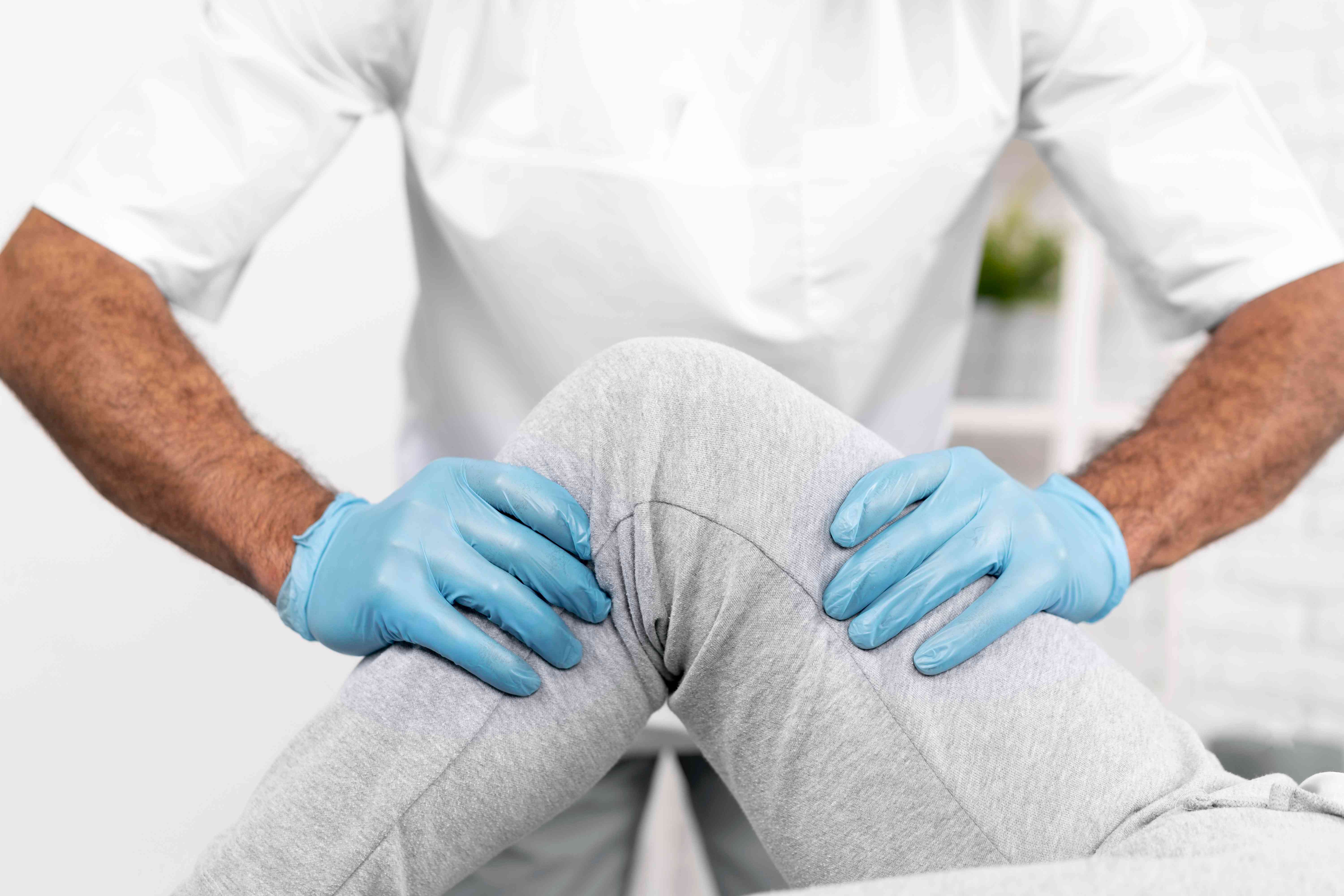 male-physiotherapist-checking-woman-s-knee-mobility-compressed