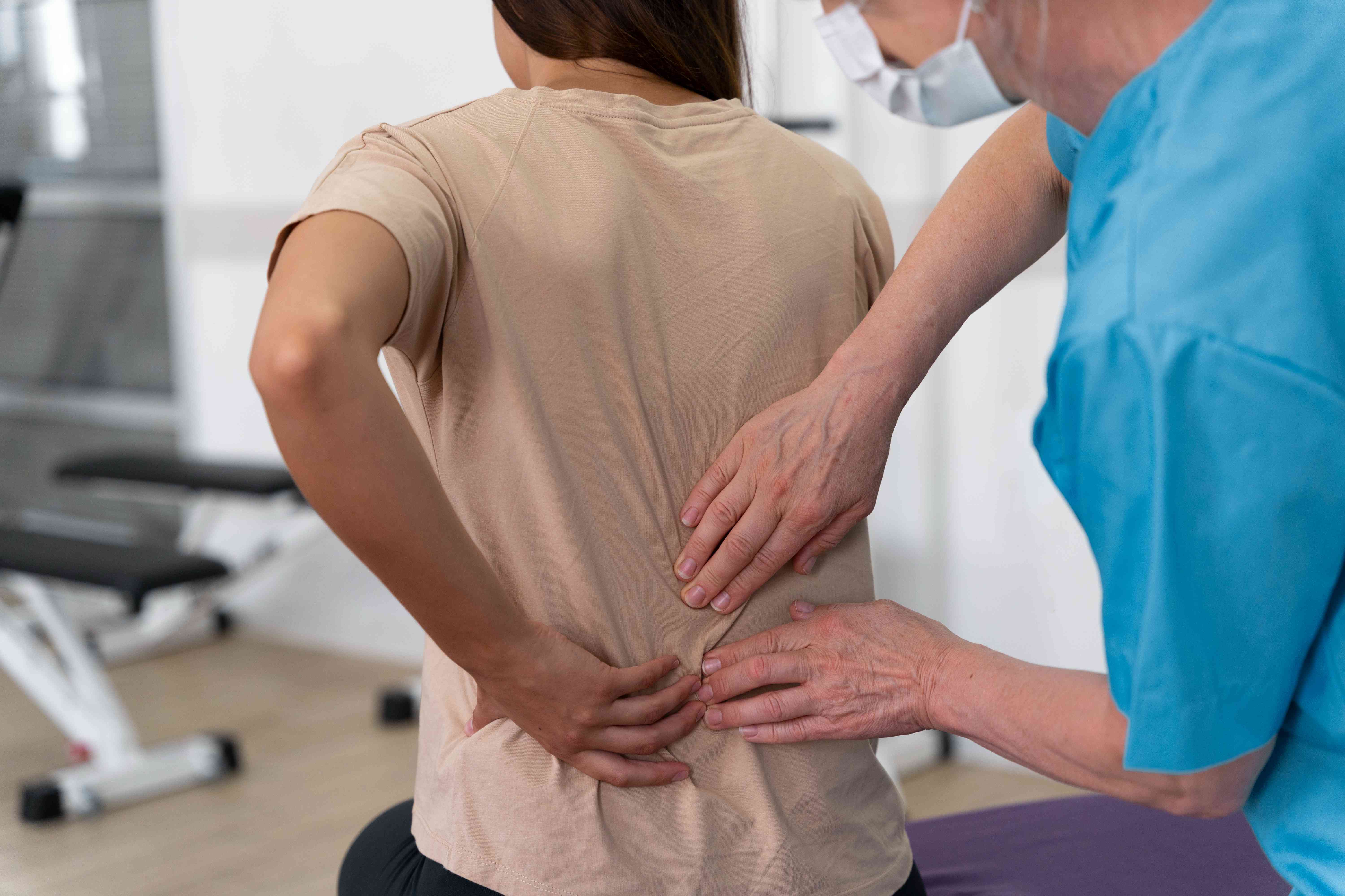 medical-assistant-helping-patient-with-physiotherapy-exercises-compressed
